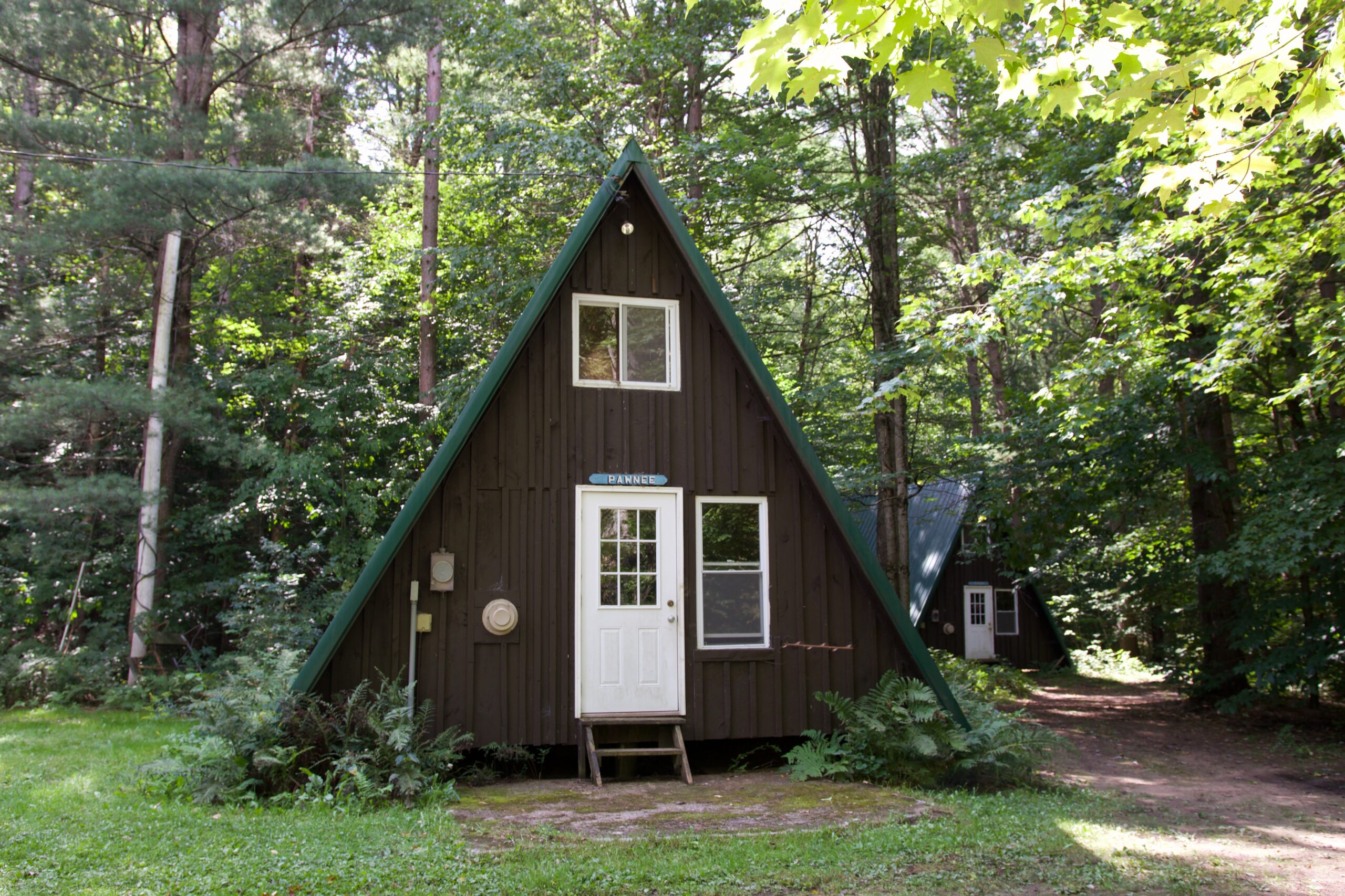 We have indoor sleeping for 30 people between 3 A-Frame cabins, located at the beginning of Camp Kingsley. These buildings offer heated sleeping space with electric plugs. Beds in these a-frames are reservation only. During warmer months they also have bathrooms with showers.